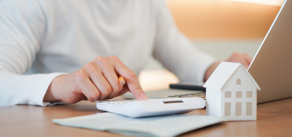 Young man calculating if it is worth refinancing